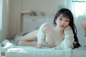 a woman sitting on top of a couch wearing a white fur coat
