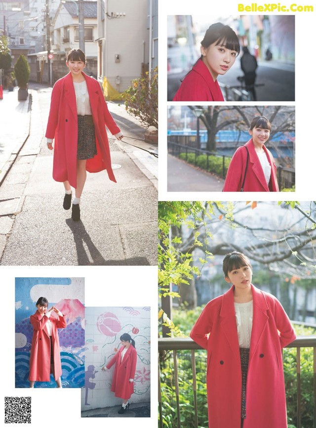 A woman in a red coat is walking down the street.