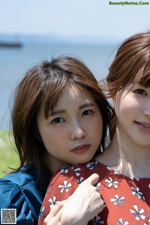 A couple of young women standing next to each other.