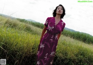 A woman in a white dress is walking down a path.