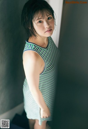 A woman with short black hair is posing for a picture.