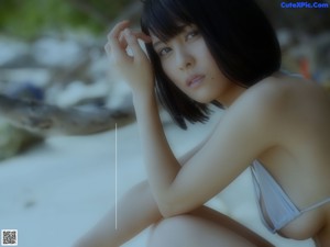 A woman in a white bikini posing for the camera.