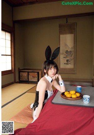 A woman sitting in a bathtub filled with water.