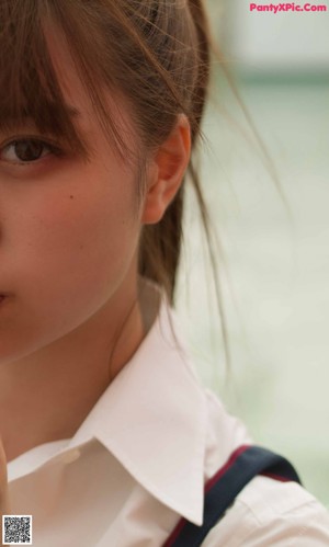 A young girl sitting at a table with a backpack.