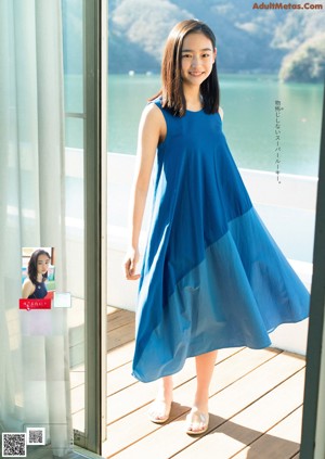 A woman in a blue and orange swimsuit posing for a magazine.