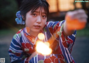 A woman laying on a tatami mat in a room.