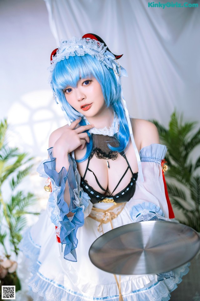 A woman dressed in a maid outfit holding a tray.