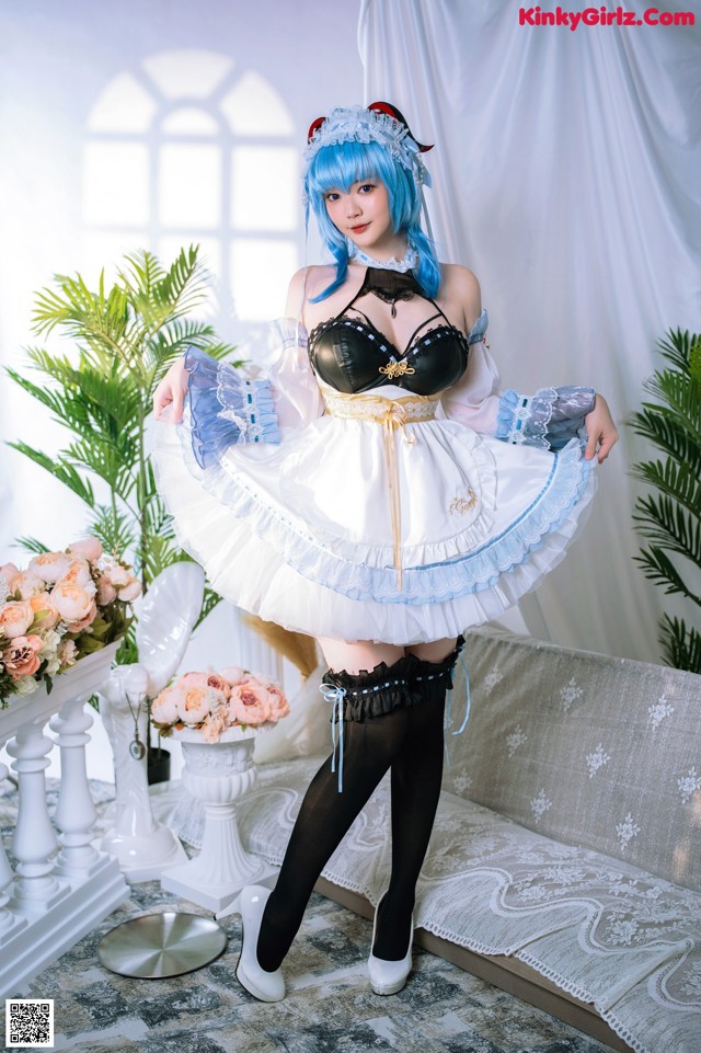 A woman dressed in a maid outfit posing for a picture.