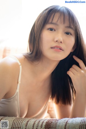 A woman in a white bikini posing for a picture.