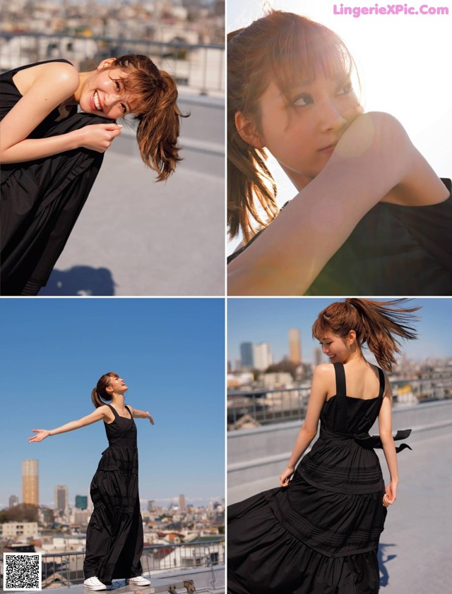 A woman in a black dress standing on top of a building.