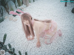 A woman in a pink bunny costume posing for a picture.