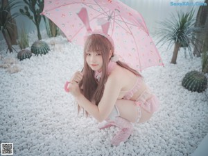 A woman in a pink bunny costume posing for a picture.